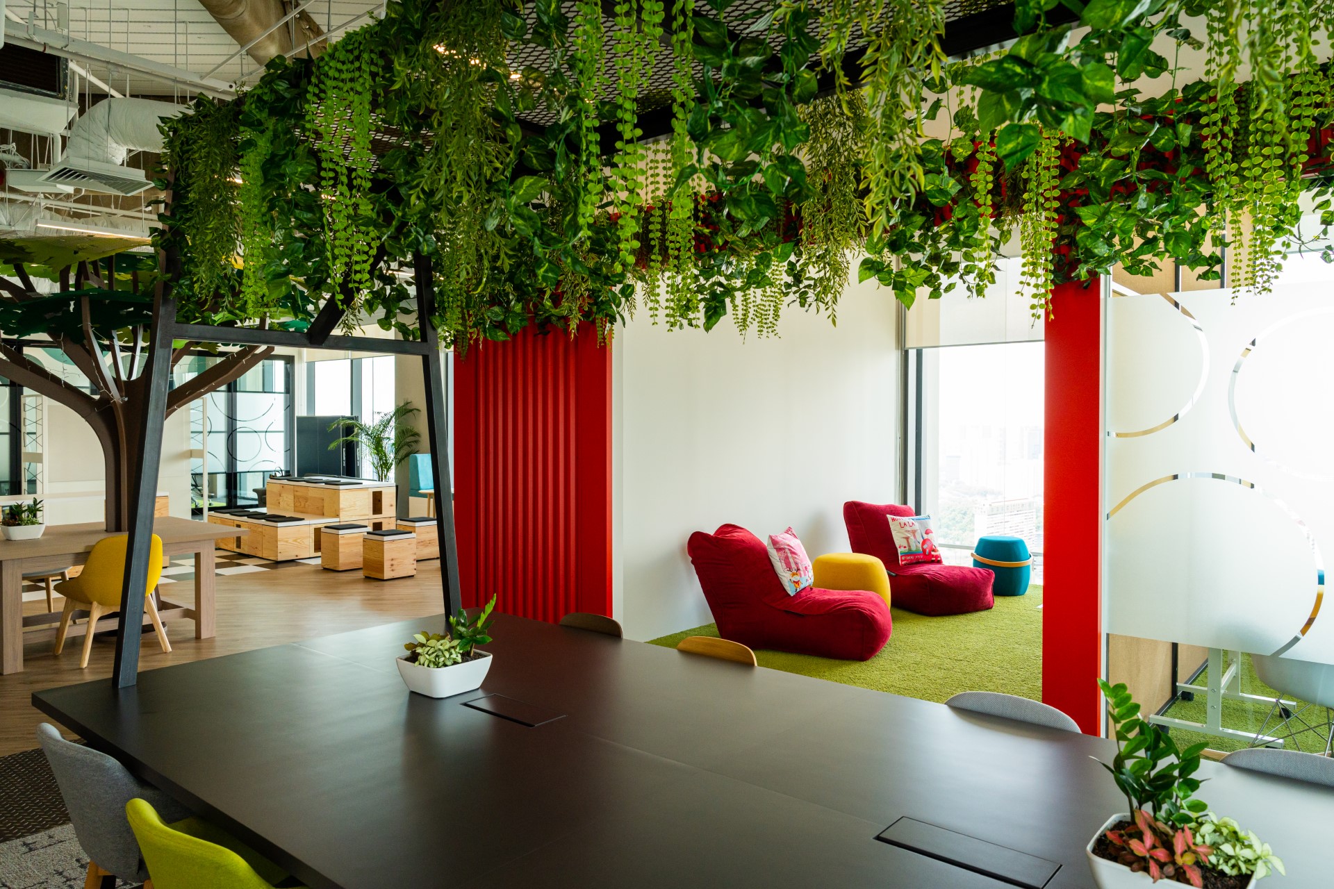 Bright open plan office with minimal partitions and greenery