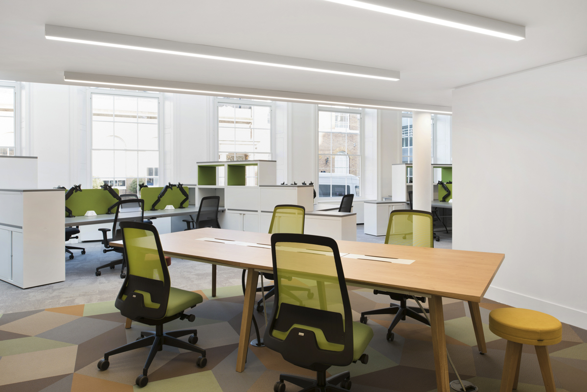 Open plan workspace with modular desks and green dividers