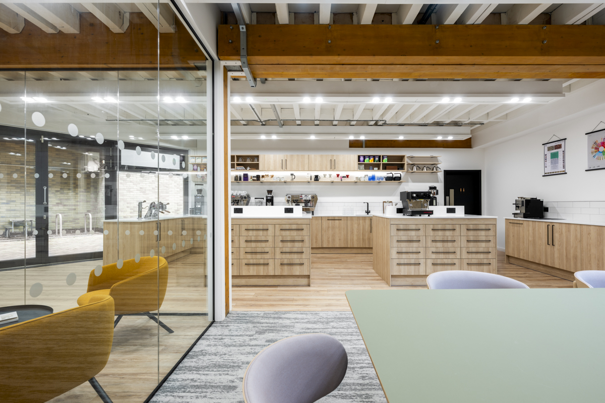Breakout space with modular seating, meeting pods and indoor plants