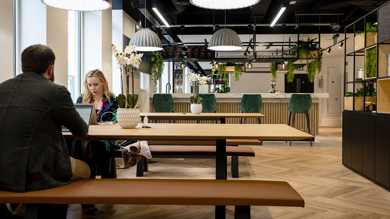 Touchdown area with high tables and open seating for short-duration work